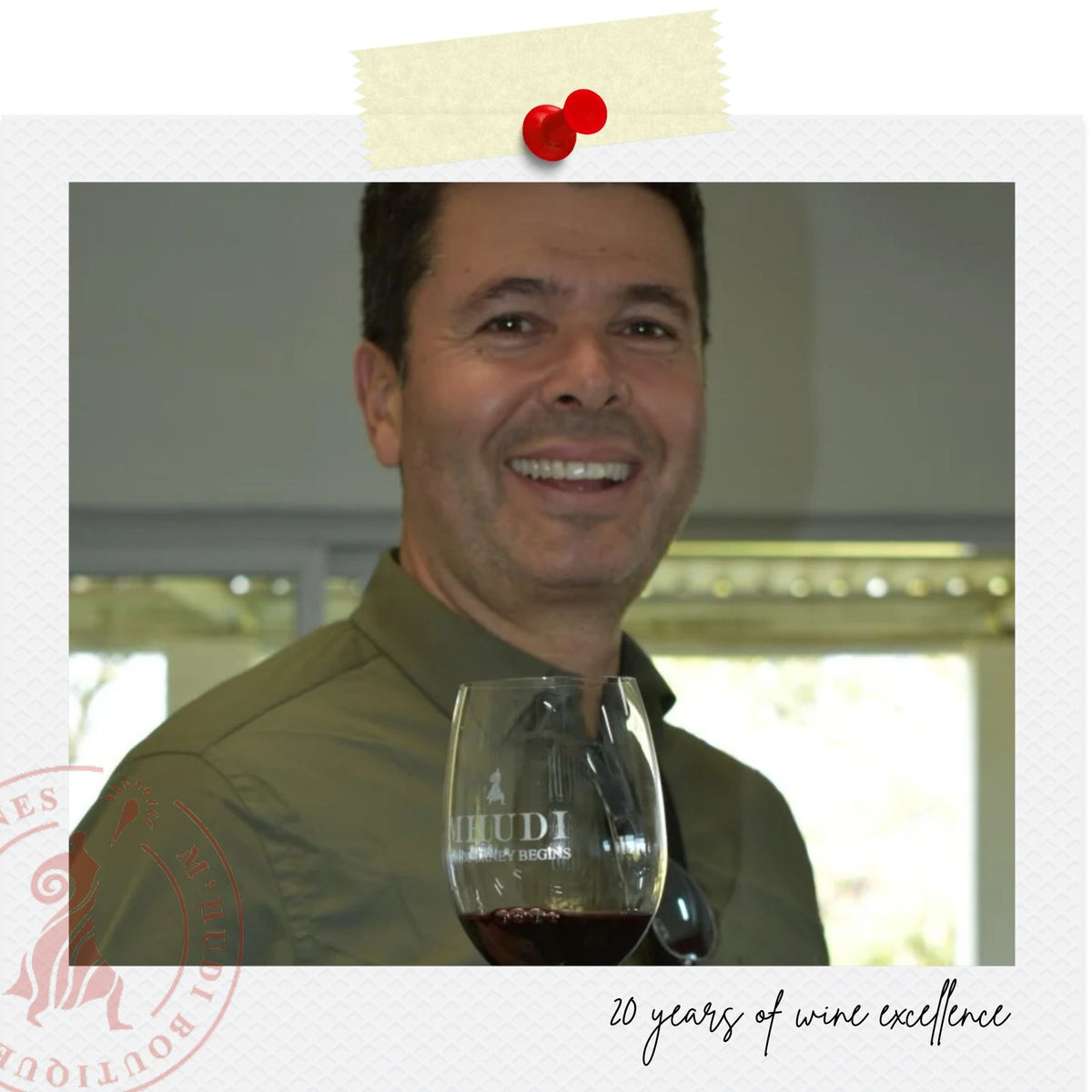 A smiling man in a green shirt holds a wine glass with red wine, set against an indoor background. The photo is styled with a white border, a beige sticky note graphic at the top, a red wine logo at the bottom left, and the text '20 years of wine excellence' at the bottom right.